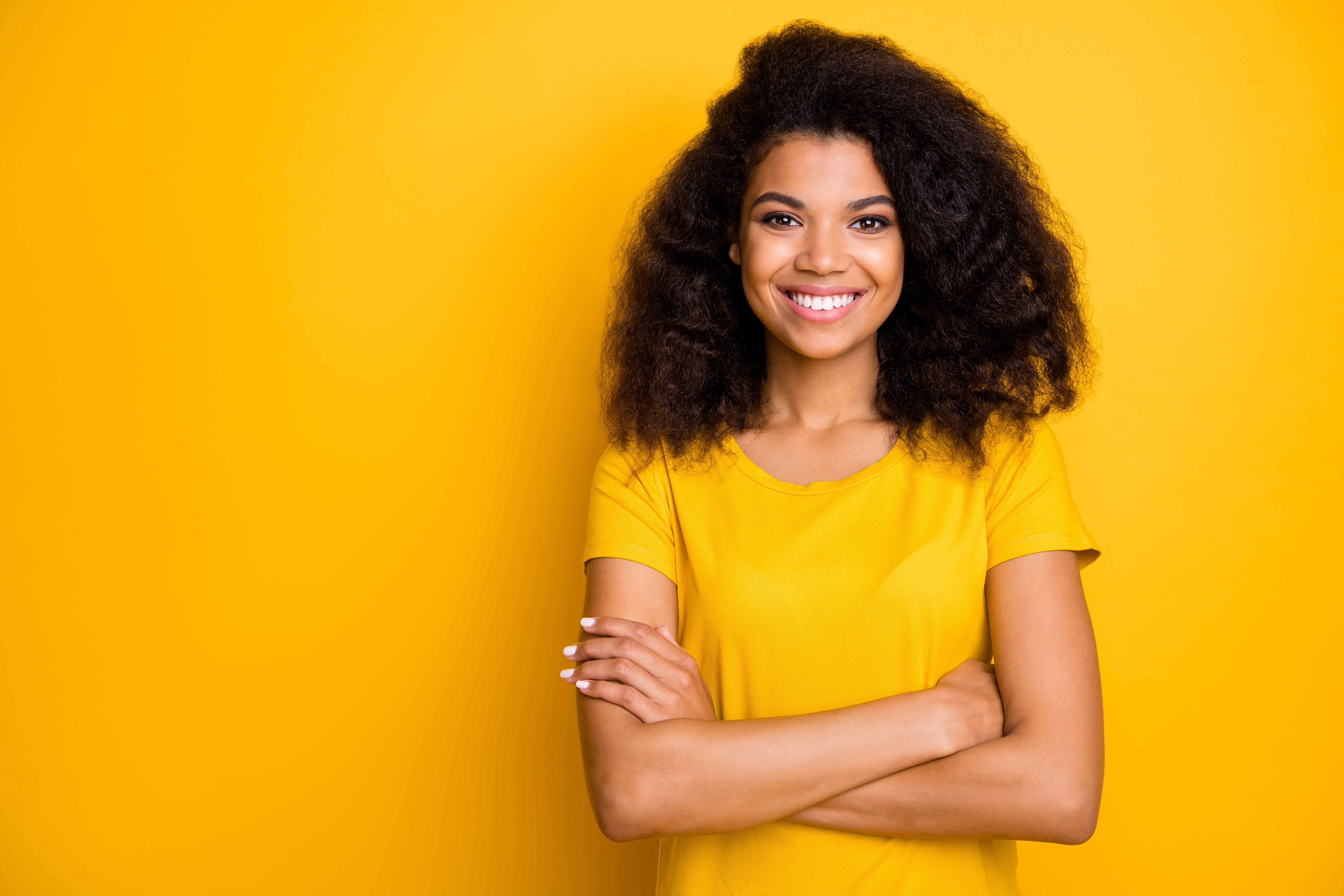 Close-up portrait of her she nice attractive lovely pretty content cheerful cheery wavy-haired girl folded arms isolated over bright vivid shine vibrant yellow color background Lakeway Ortho